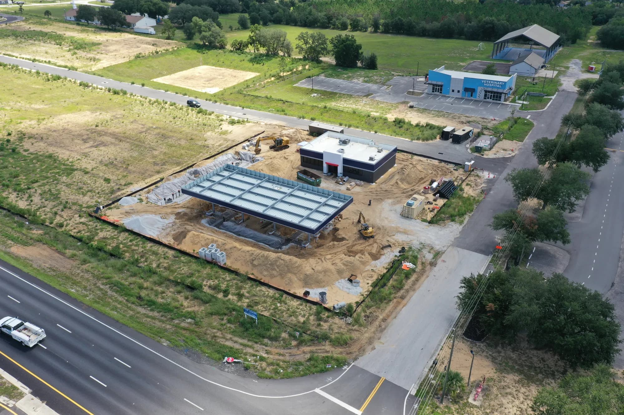 Aerial of a fuel station under construction on a pad beside a Florida highway