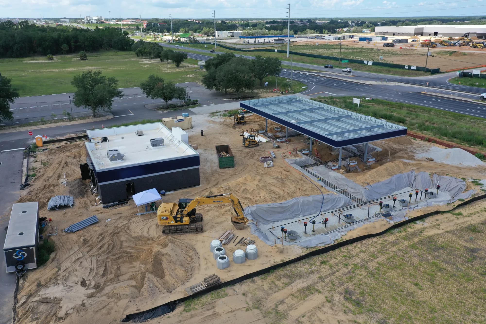Aerial of an underground fuel tank field with piping and vent risers under a protective liner