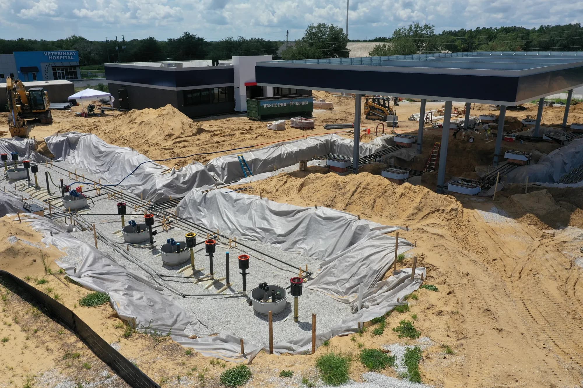 Close aerial of underground fuel piping runs leading to the fuel canopy