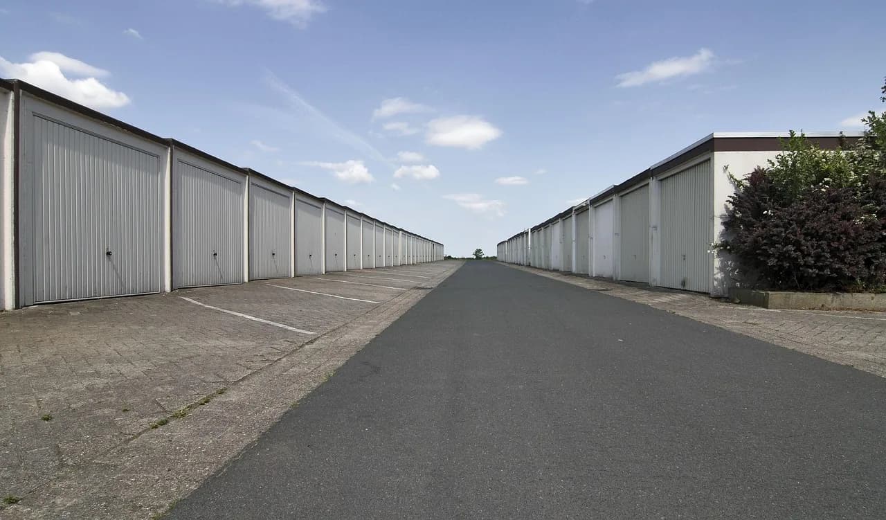 Row of drive-up self-storage units under blue sky
